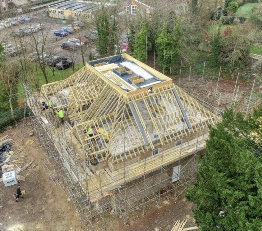 Aerial view of a new roof structure under construction, timber trusses and scaffolding